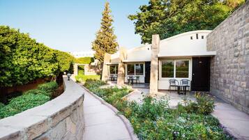 A modern building with outdoor seating and a stone pathway.