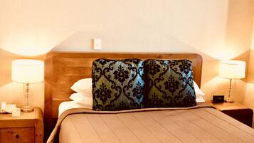 A hotel room with a bed, two nightstands, and lamps.