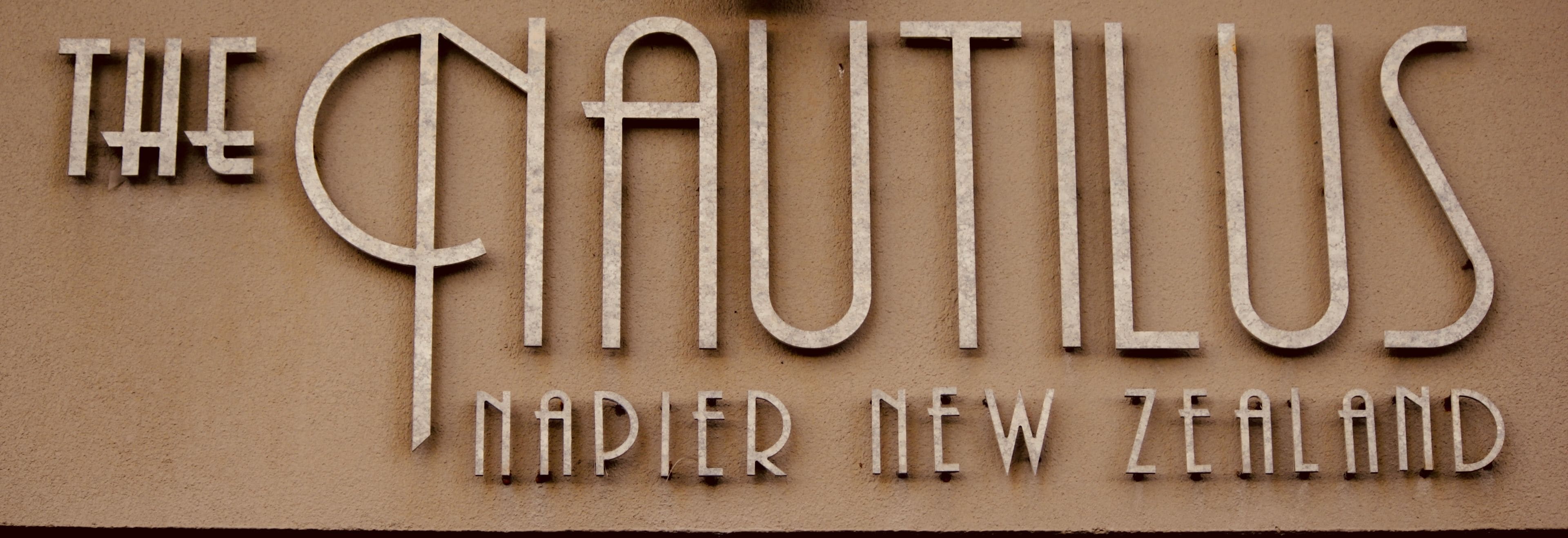 A sign with the text "The Nautilus" and "Napier New Zealand" indicating a location.