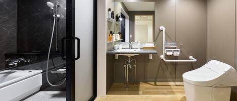 A modern bathroom with a bathtub, a toilet, and a sink.