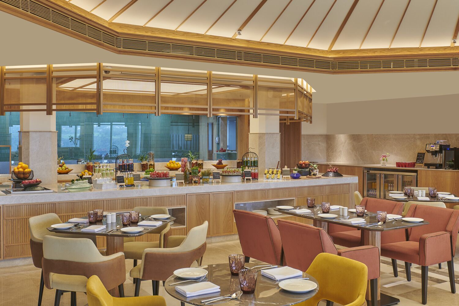 A modern restaurant with a central bar, multiple dining tables, and a variety of food and drink options.