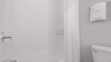 A bathroom with a shower, toilet, and a towel rack.