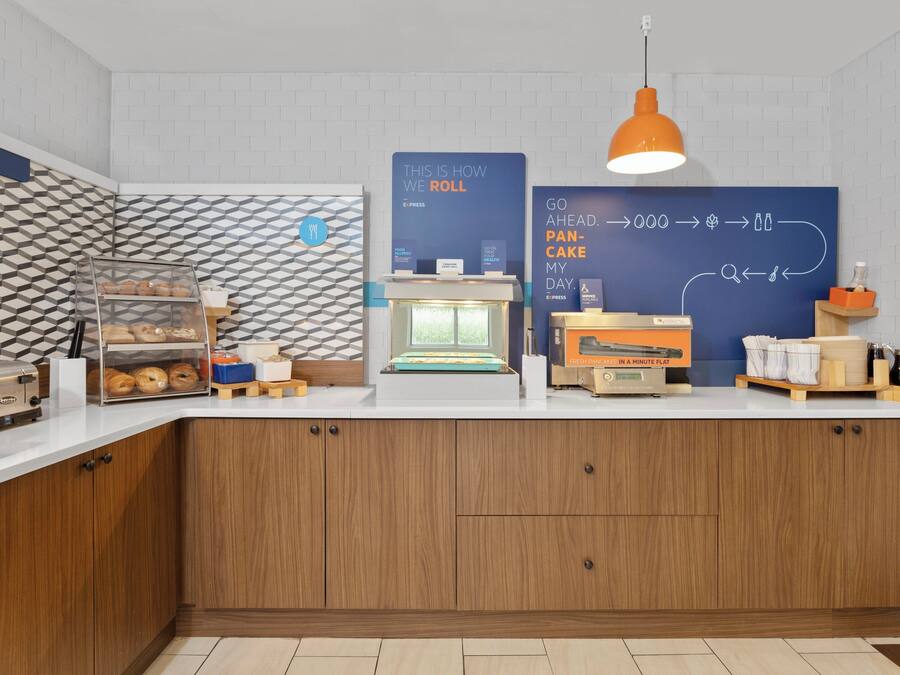 A bakery counter with a display case, a bread oven, and a sign explaining the bread-making process.