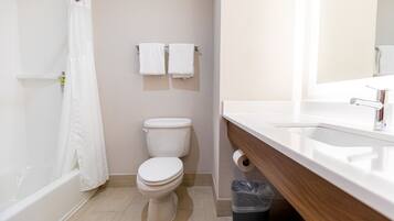 A bathroom with a bathtub, toilet, and sink.
