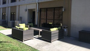 An outdoor patio area with wicker furniture and a concrete floor. - Holiday Inn Express Johnson City by IHG (Johnson City)
