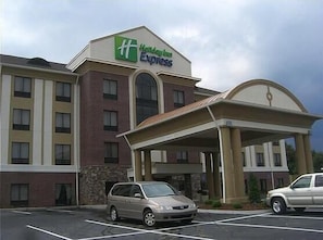 A Holiday Inn Express building with a parking lot and a covered entrance.
