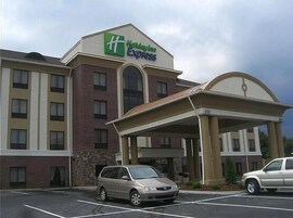 Edificio de Holiday Inn Express con estacionamiento y entrada cubierta.