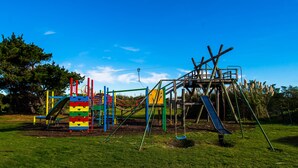 A playground with various play structures including slides and swings. - Charles Court Motel (Greymouth)