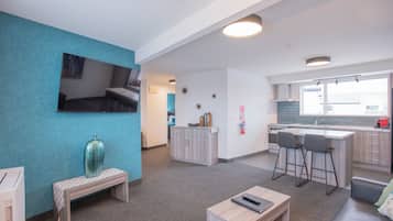 Luxury Suite, 1 Bedroom | Living area | 55-inch Smart TV with satellite channels