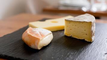 A selection of cheeses on a slate board.