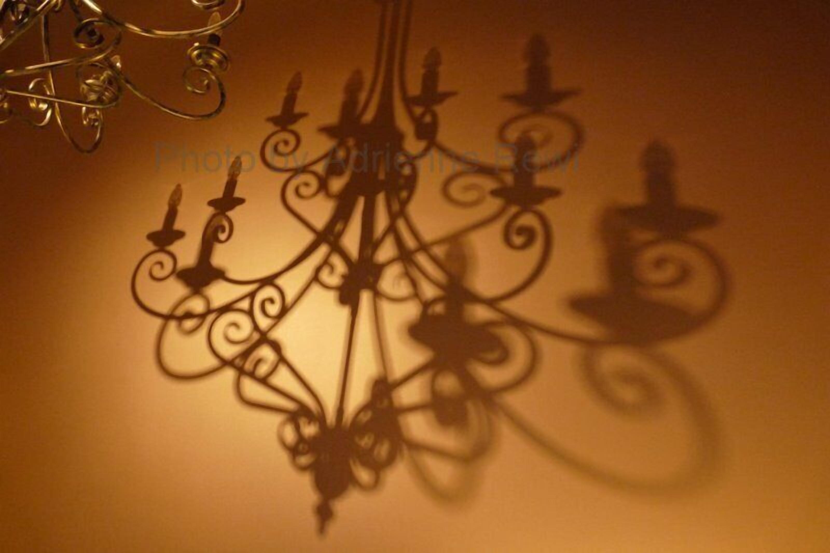 Un candelabro con ornamentos metálicos elaborados y luces similares a velas.