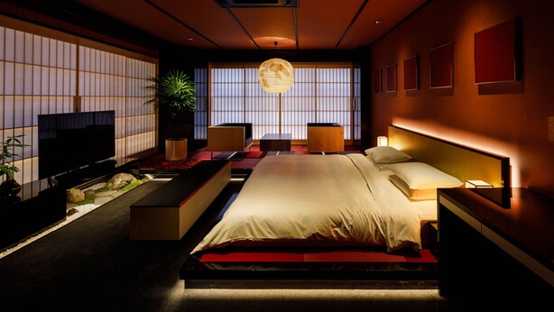 A modern bedroom with a large bed, bedside tables, a TV, and a large window with a view. - The Screen (Kyoto)