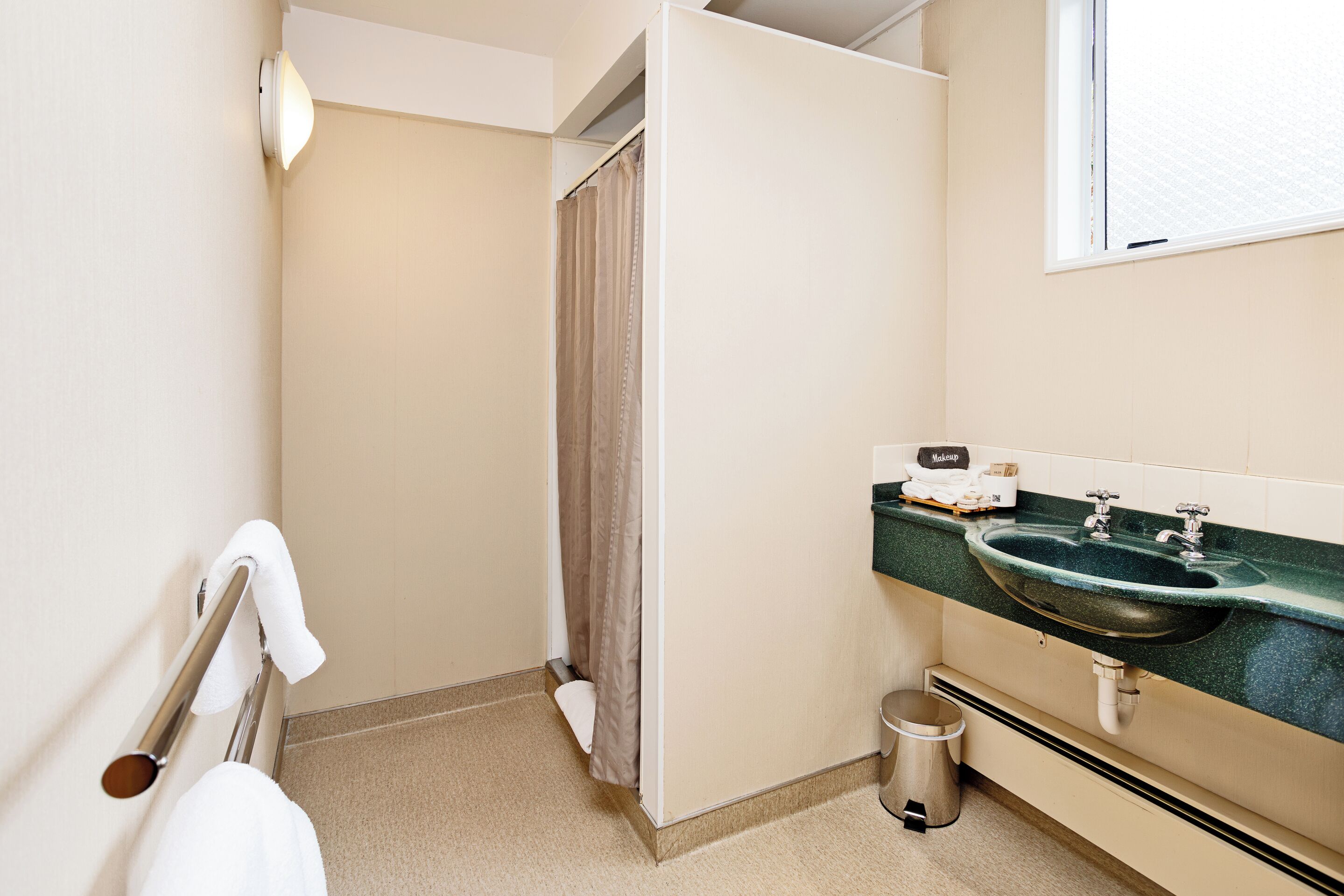 A bathroom with a sink, toilet, and shower curtain.