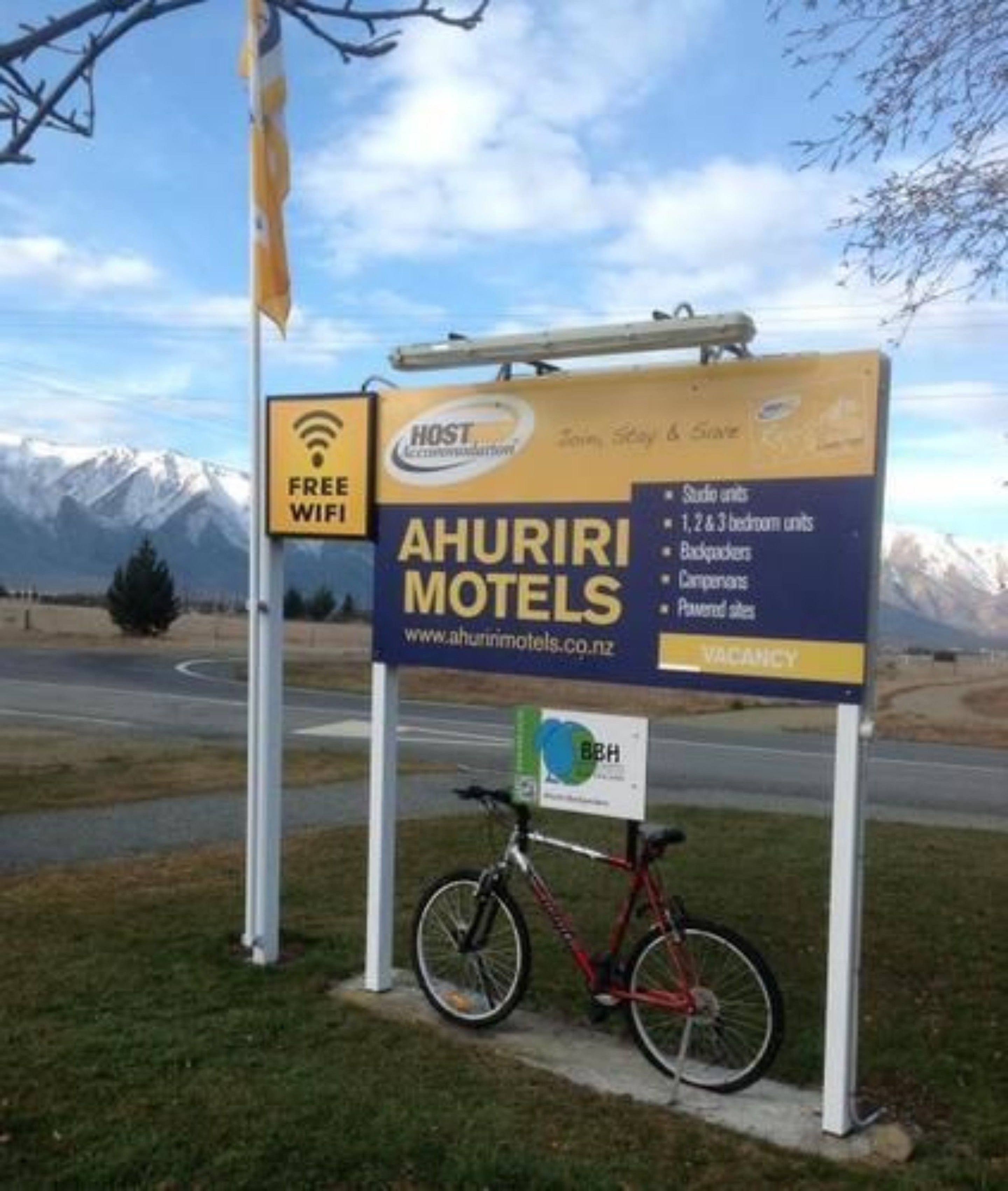 A sign for Ahuriri Motels advertising free WiFi, studio, 1 & 2 & 3 bedroom units, backrooms, companions, and parking.