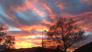 A sunset with vibrant clouds over a residential area.