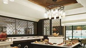 A spacious kitchen with a marble countertop, various food items, and a decorative hanging light fixture. - The Connaught, New Delhi - IHCL SeleQtions (New Delhi)