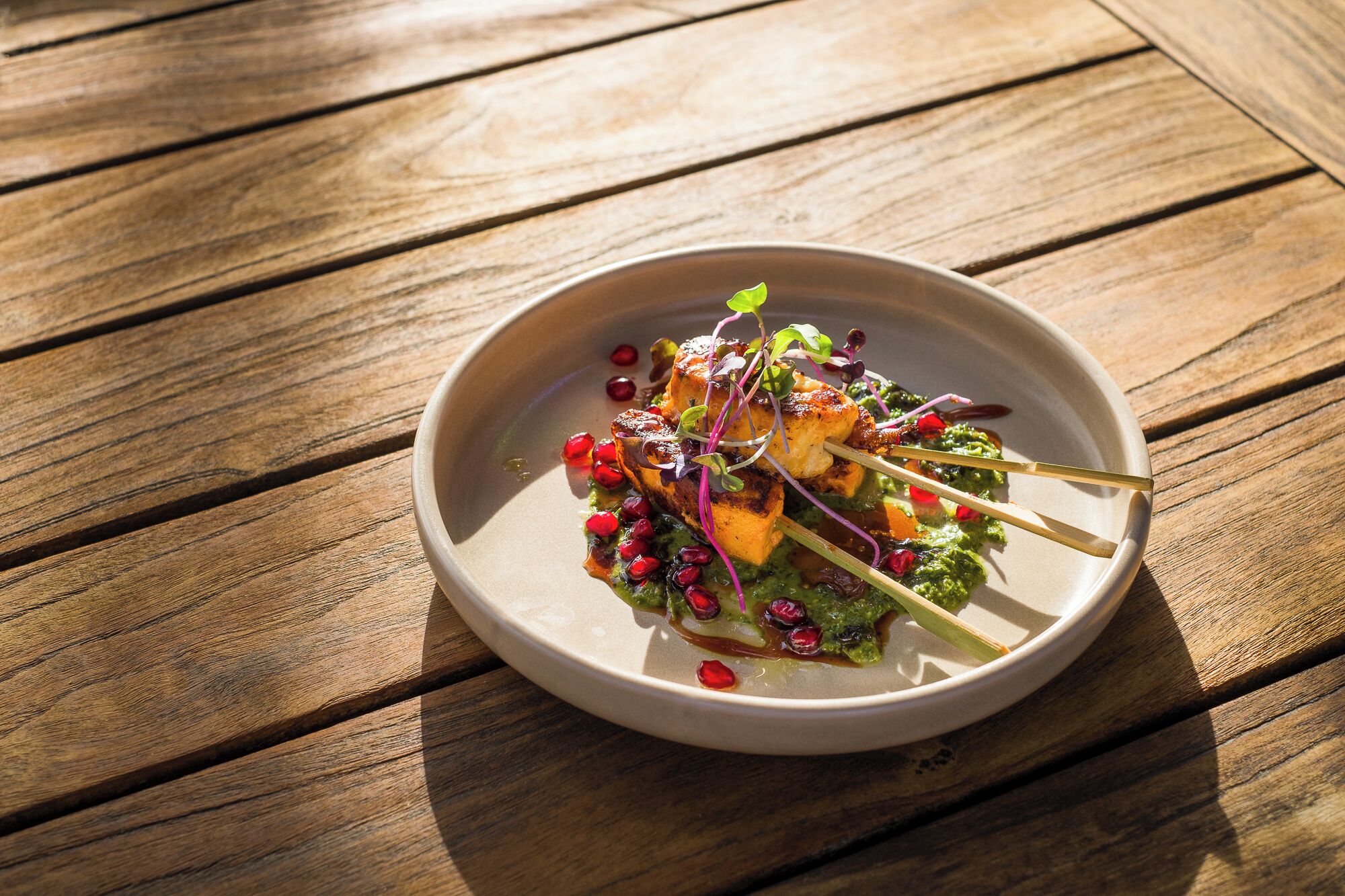 A plate of food on a wooden table.