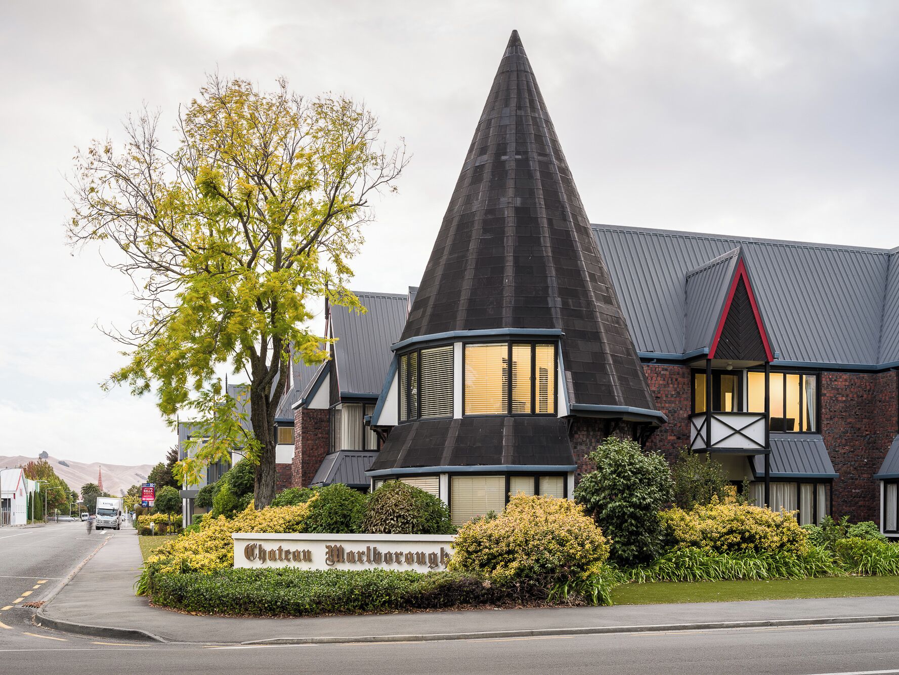 Chateau Marlborough, a building with a distinctive conical roof and a signboard.