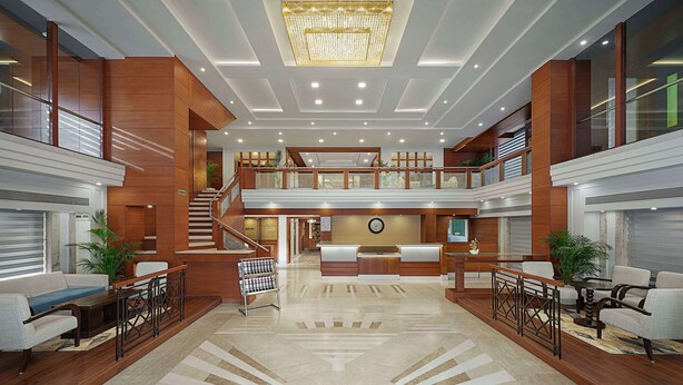 A spacious lobby with a reception desk, seating area, and a staircase leading to an upper level. - Best Western Plus Indore (Indore)
