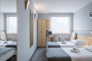 A hotel room with two beds, a desk, a chair, a wardrobe, and a large window. - Days Hotel Wroclaw (Wroclaw)