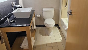 A bathroom with a white toilet, a sink, and a bathtub.