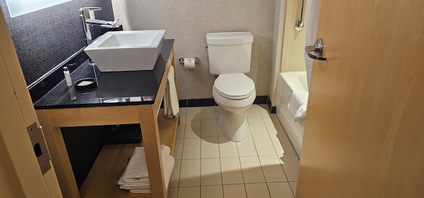 A bathroom with a white toilet, a sink, and a bathtub.