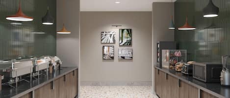 A modern kitchen with a long counter, overhead pendant lights, and a tiled backsplash.