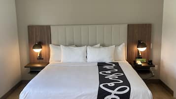 Premium bedding, desk, laptop workspace, blackout drapes