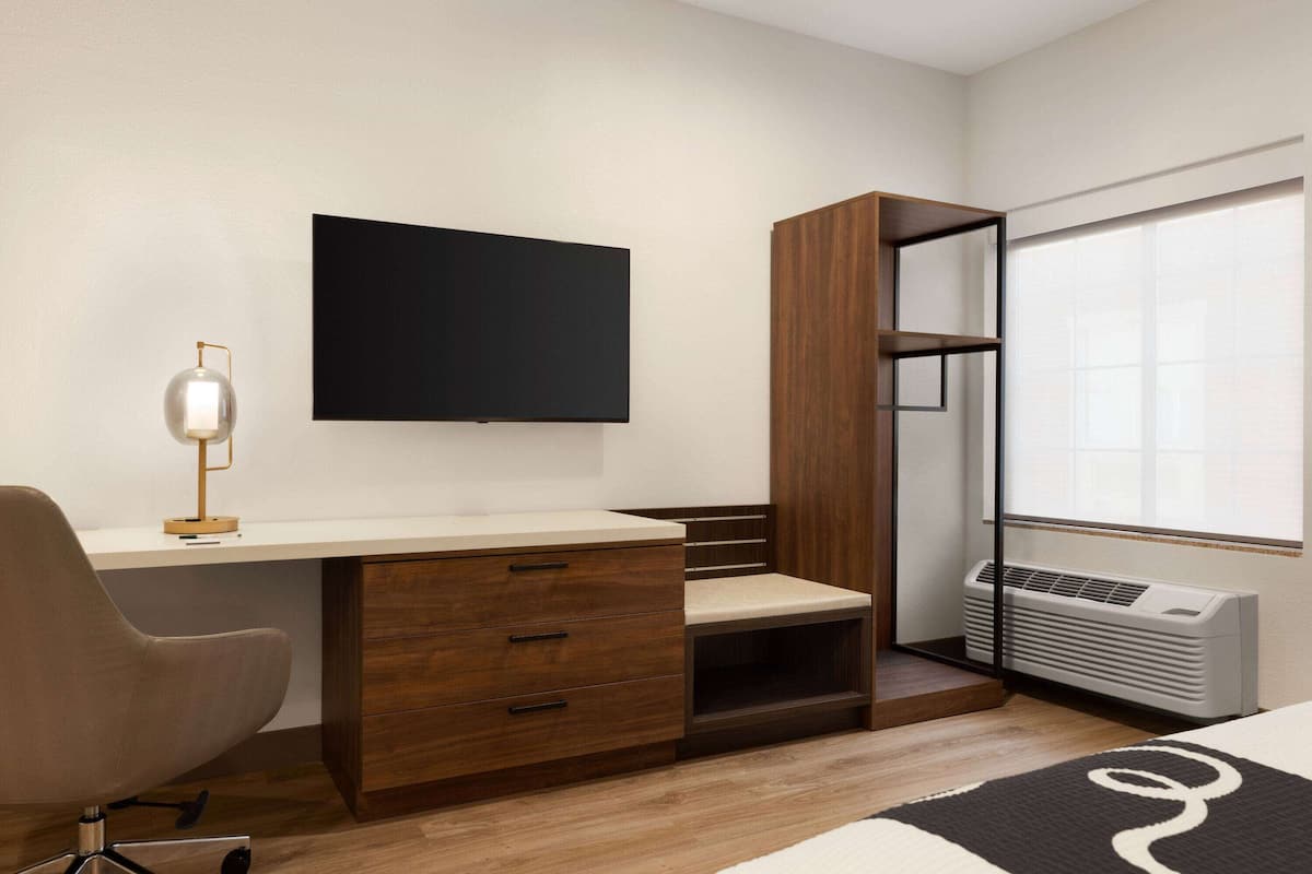 Premium bedding, desk, laptop workspace, blackout drapes