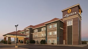 A multi-story hotel with a prominent 'La Quinta' sign, featuring a sun logo. - La Quinta Inn & Suites by Wyndham Tucumcari (Tucumcari)