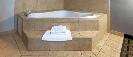 A modern bathroom with a freestanding bathtub, a built-in shower, and a towel rack.