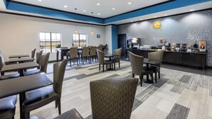 A hotel lobby with a seating area, a reception desk, and a view of the outdoors. - La Quinta Inn & Suites by Wyndham Mt. Pleasant (Mount Pleasant)
