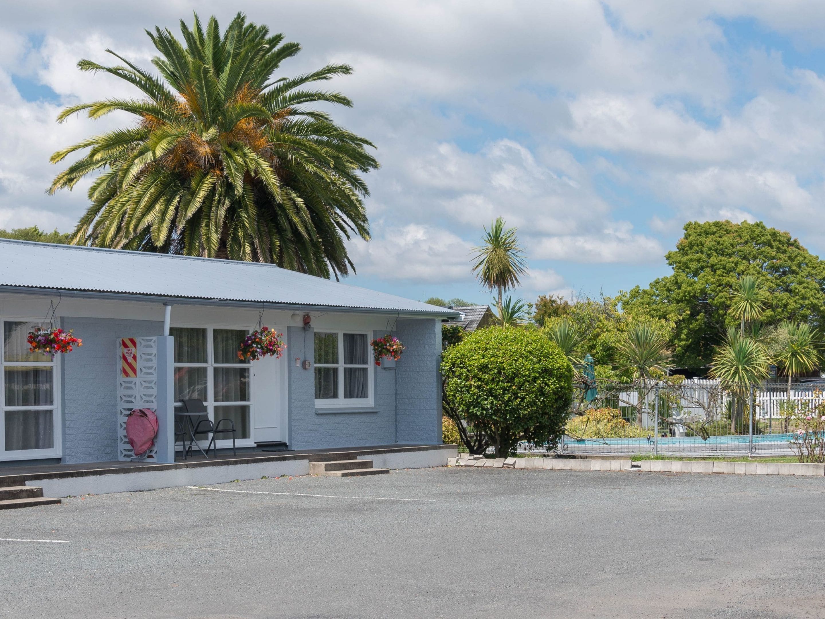 A single-story building with a flat roof, a front porch, and a small entrance.