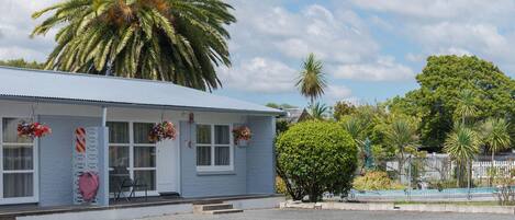 A single-story building with a flat roof, a front porch, and a small entrance.