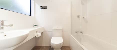 A bathroom with a white sink, toilet, and bathtub.