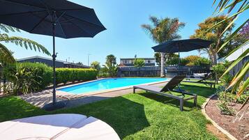 Outdoor pool, open 9:00 AM to 8:00 PM, pool umbrellas, pool loungers