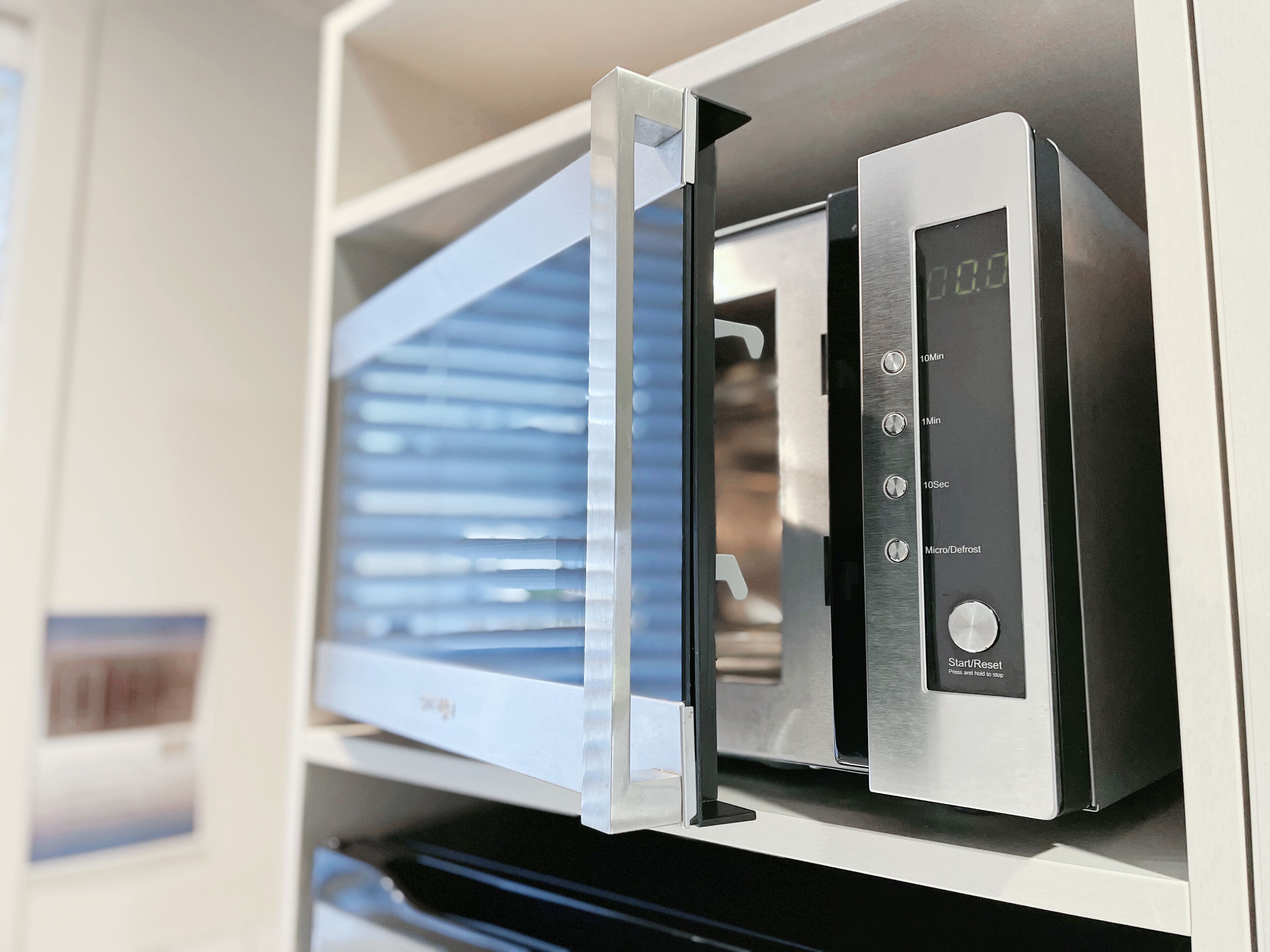 A microwave oven with a digital display and control buttons.