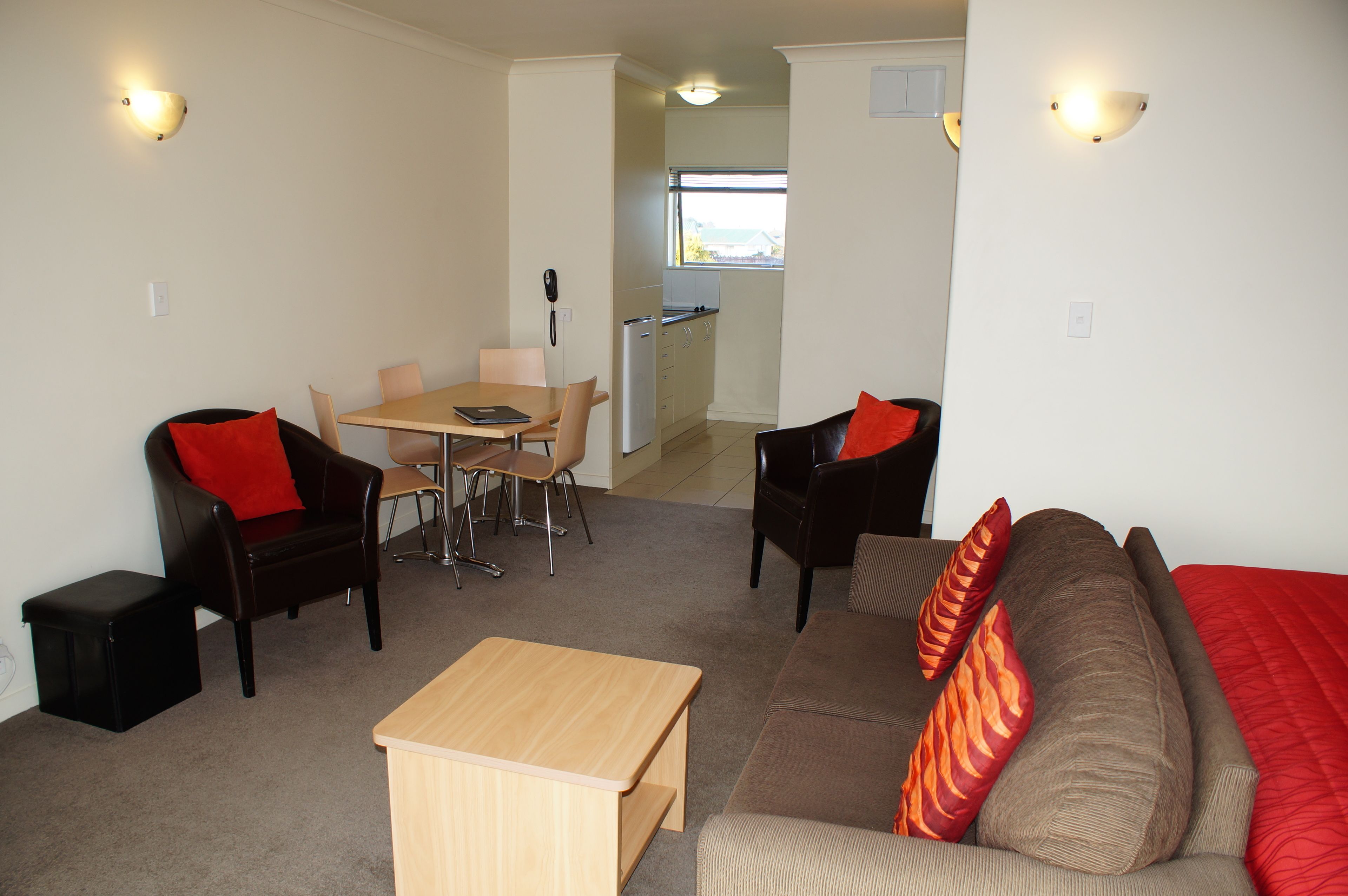 A compact living space with a dining area, a sofa, and a small table.