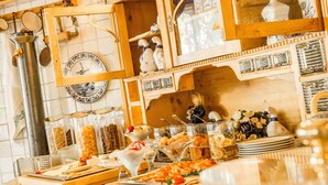 A buffet setup with various food items and serving utensils.