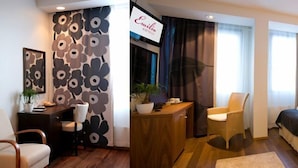Une chambre d’hôtel avec un lit, un bureau, une chaise, une plante en pot et un téléviseur.