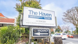 A sign for The Haven Newmarket Suites with a vacancy arrow.