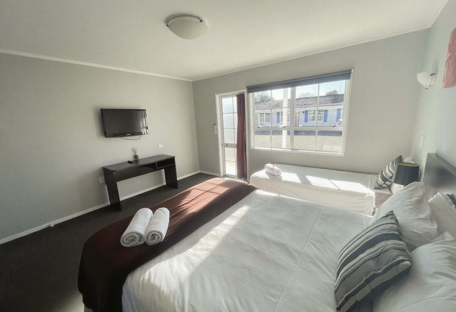 Premium bedding, desk, laptop workspace, iron/ironing board