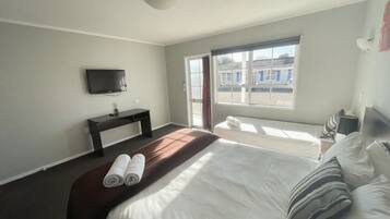 Premium bedding, desk, laptop workspace, iron/ironing board