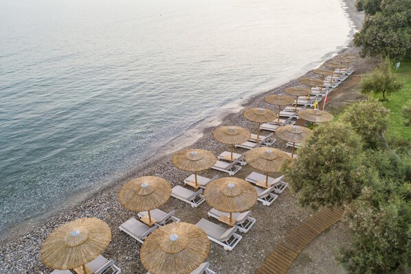 On the beach, sun-loungers, beach umbrellas, beach towels