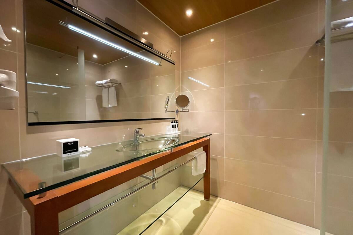 comfort room | bathroom | hair dryer, towels, soap, shampoo