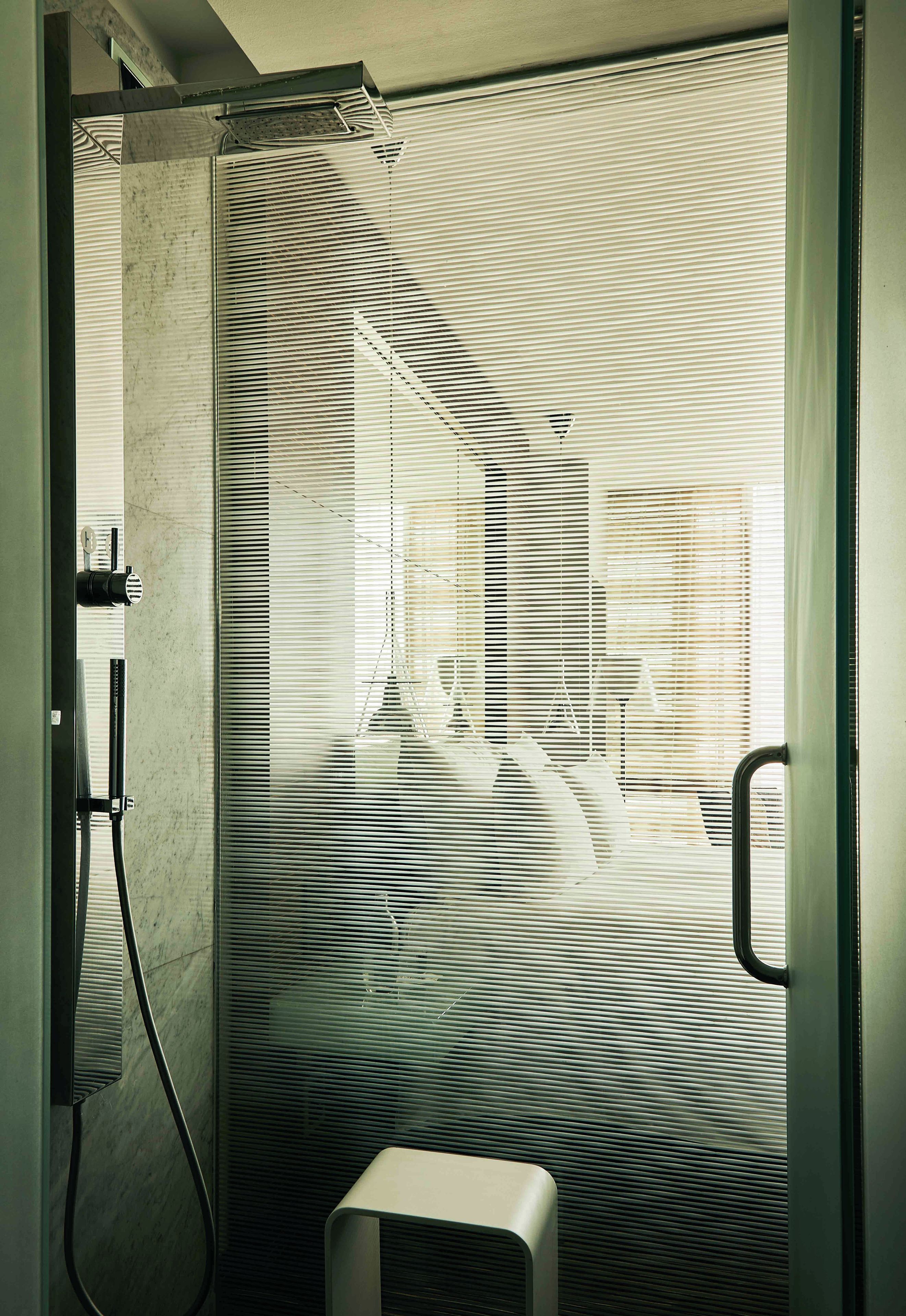 A bathroom with a shower, a toilet, and a sink.