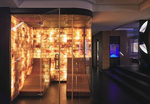 A modern interior with a wooden wall design, a staircase, and a blue-lit area.