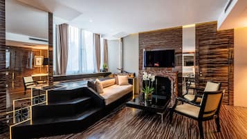A modern living room with a sofa, a coffee table, and a fireplace.