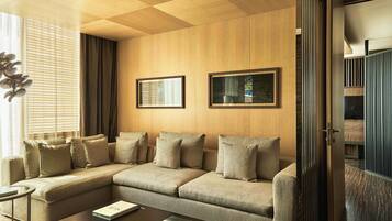 A modern living room with a sectional sofa, a coffee table, and two framed pictures on the wall.