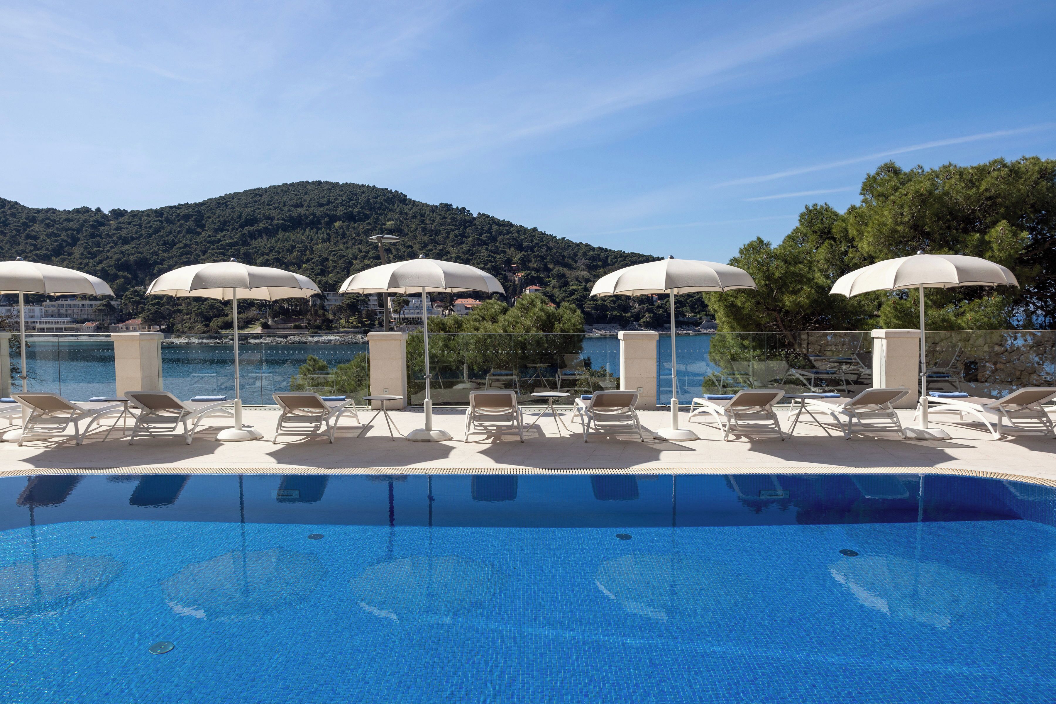 Seasonal outdoor pool, open 8:00 AM to 8:00 PM, pool umbrellas